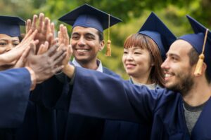 Happy students high fiving after graduation