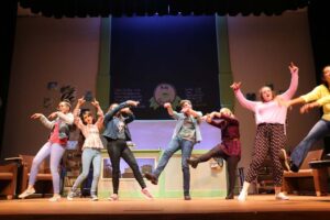 Group of theater kids performing Godspell