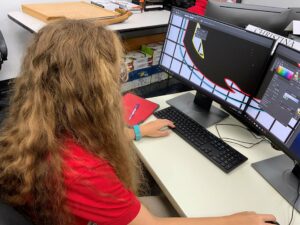 Student creating digital art on computer