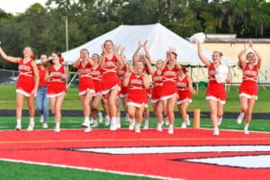 Cheerleaders running onto field