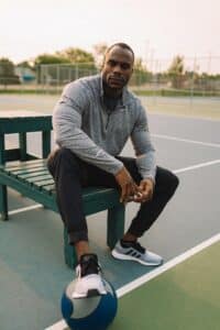 Karsten Wingeart sitting on bench with ball