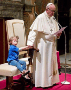 Child holding Pope Francis hand